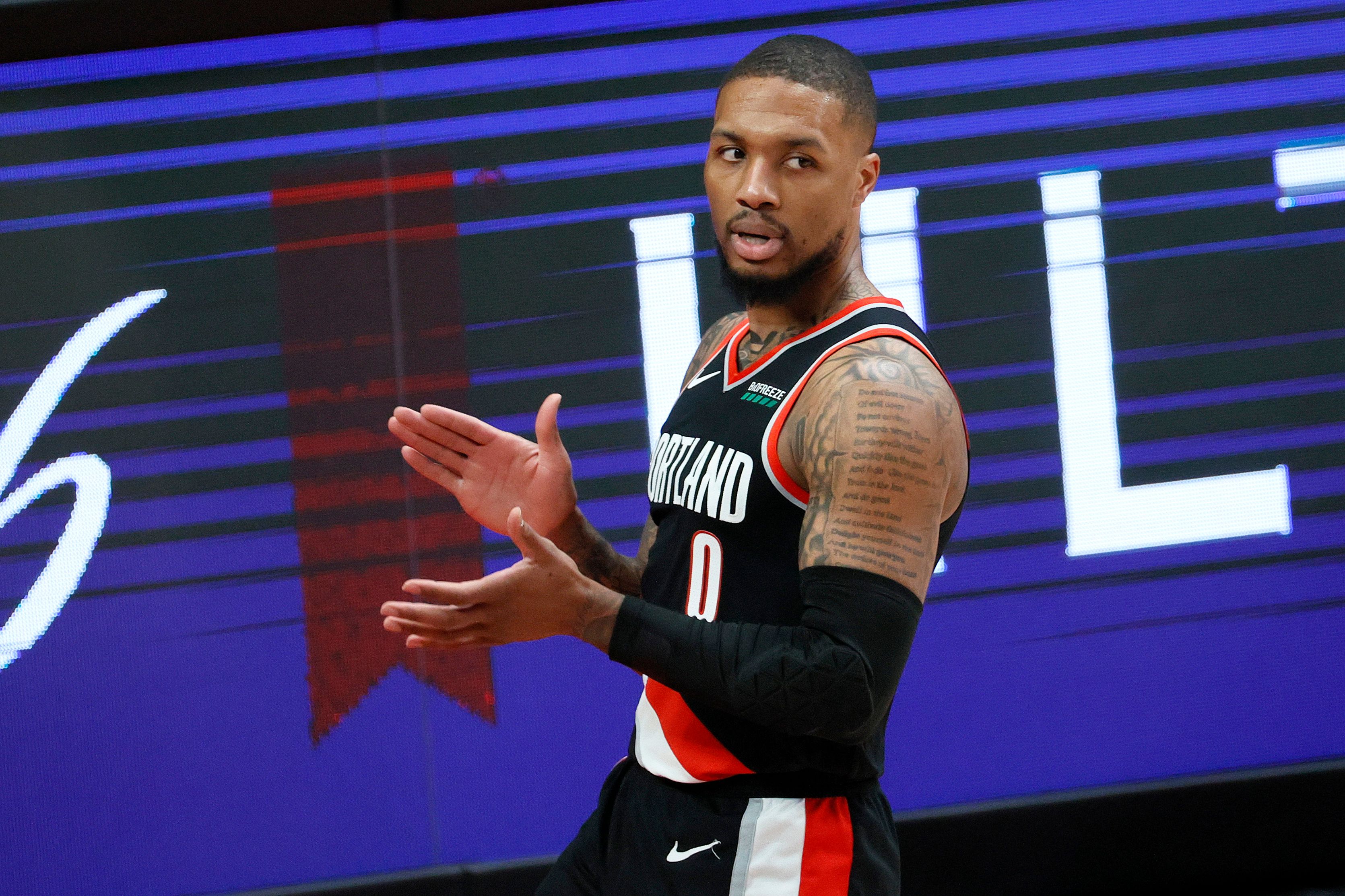Damian Lillard clapping after getting a favorable call from the ref