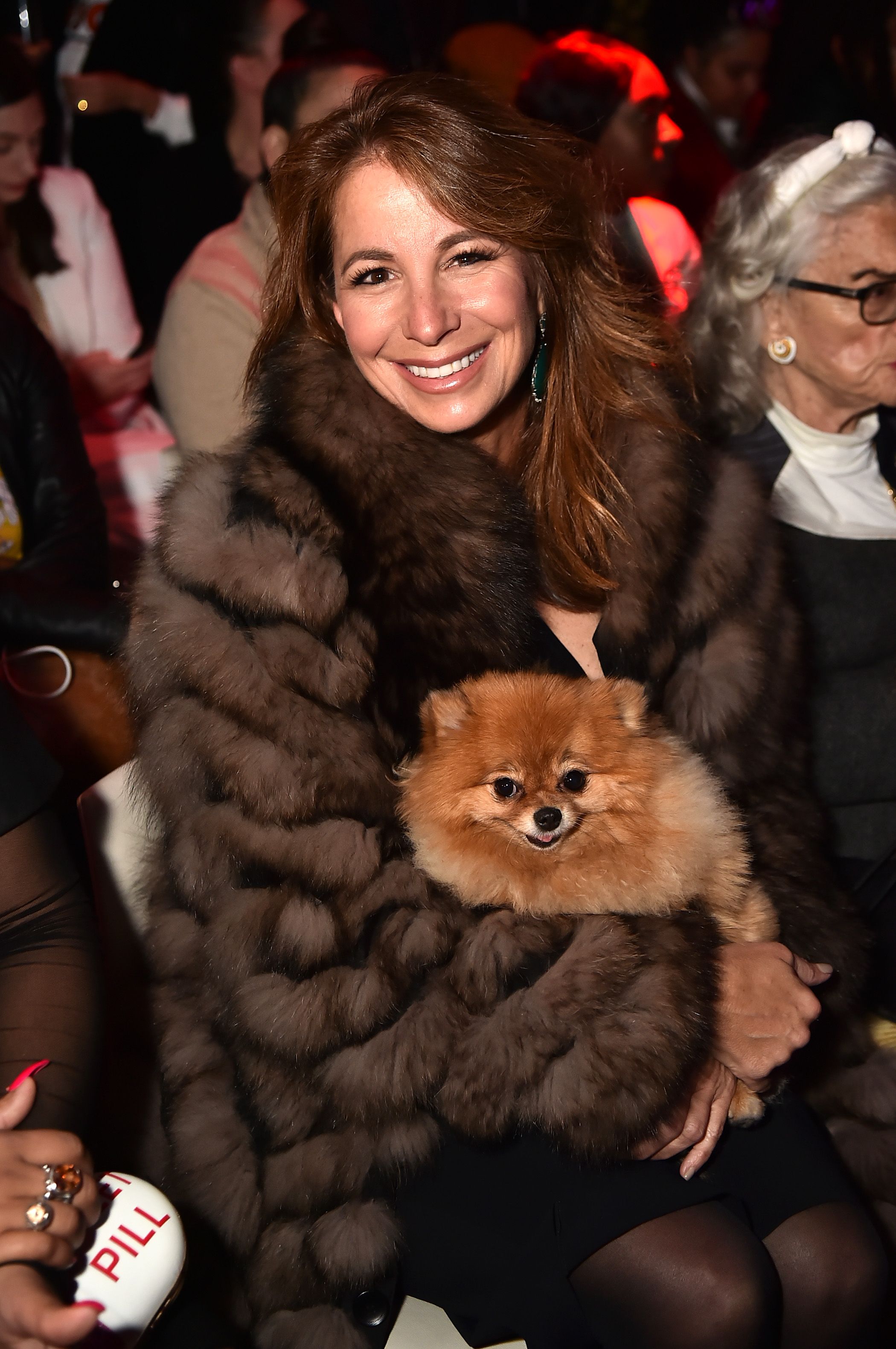 Jill Zarin wears fur and holds her dog.