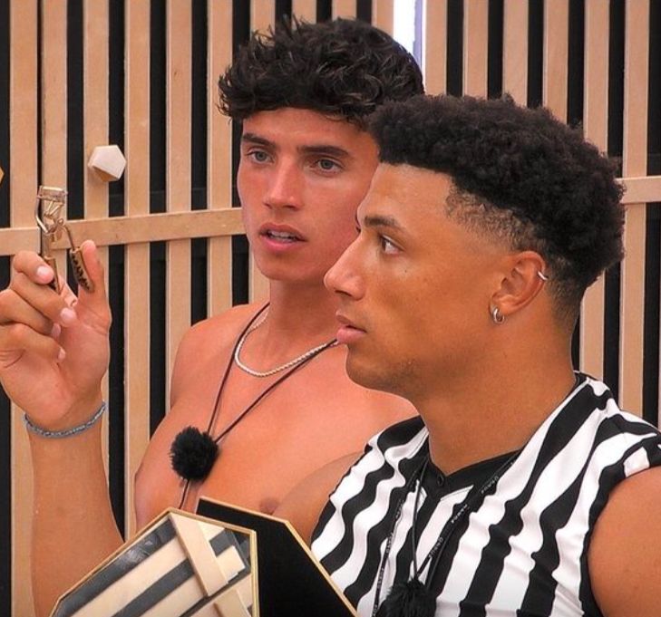 Cam Holmes and Chase DeMoor look confused by an eyelash curler.