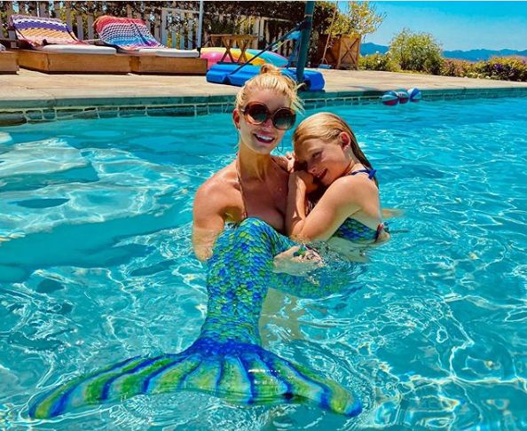 Jessica Simpson poses in the pool with her daughter