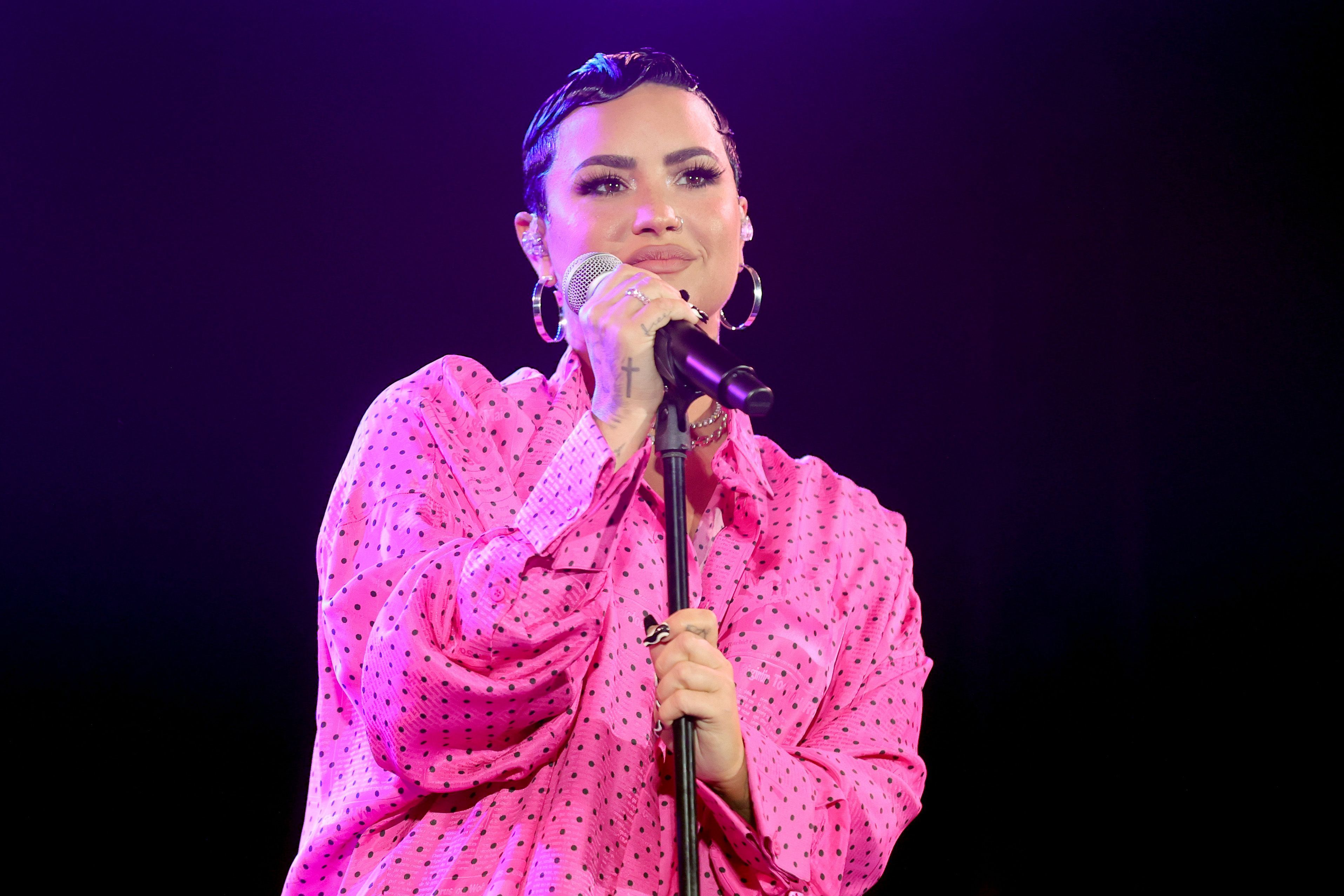 Demi Lovato wears a hot pink polka-dot button-down.