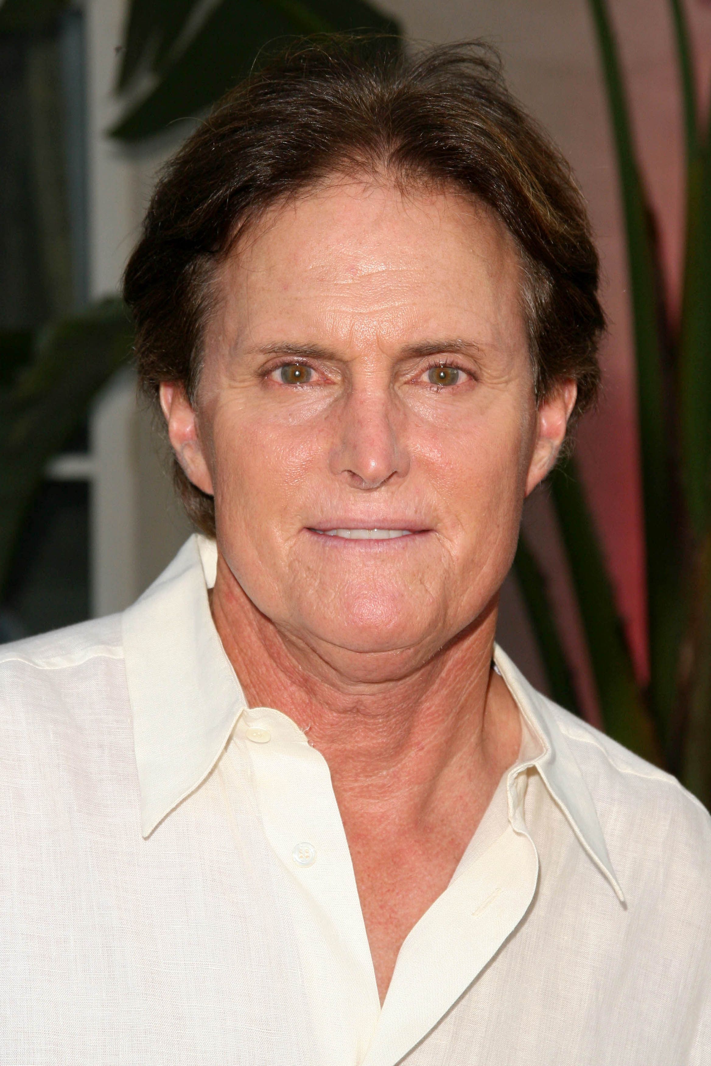 Bruce Jenner in a white button-down shirt.