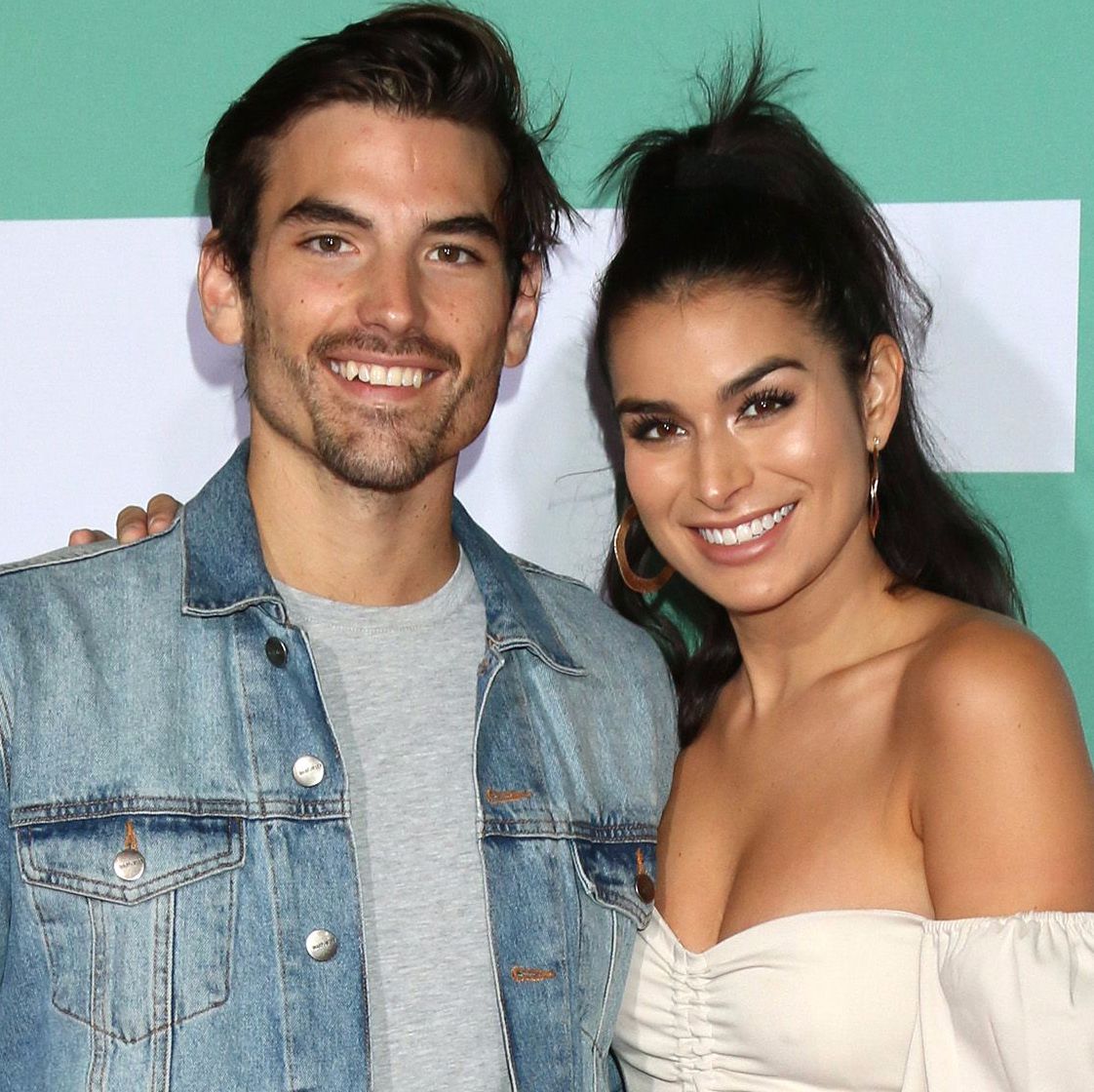 Jared Haibon wears a jean jacket with Ashley Iaconetti in a strapless top.