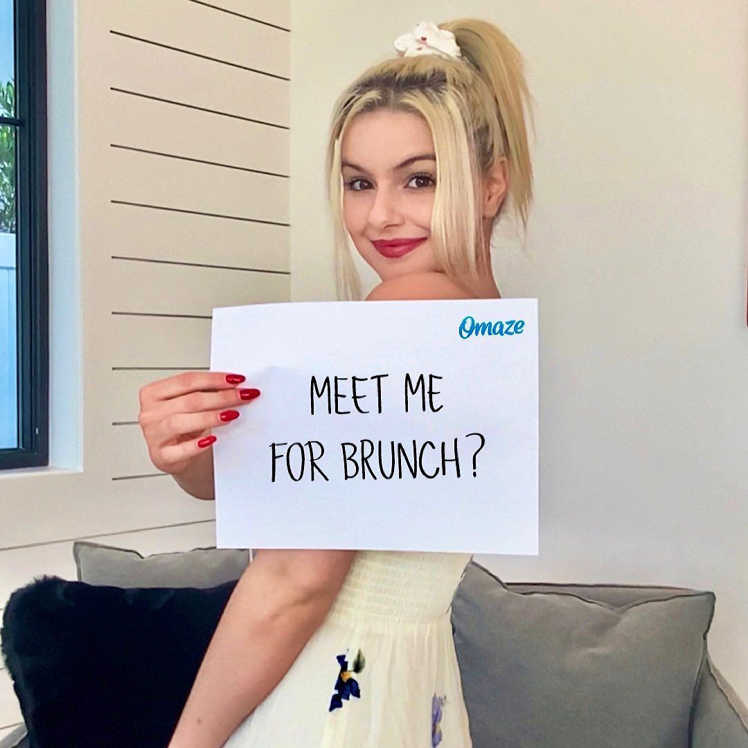 Ariel Winter with brunch sign