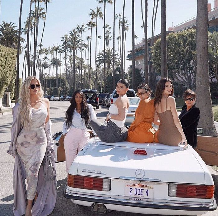 Kardashians together on a car