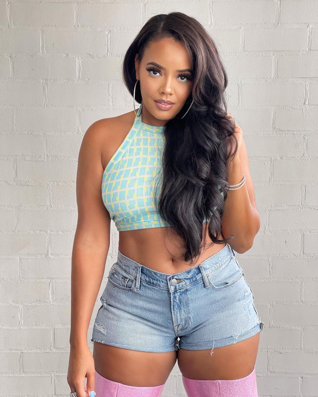 Angela Simmons in shorts and boots