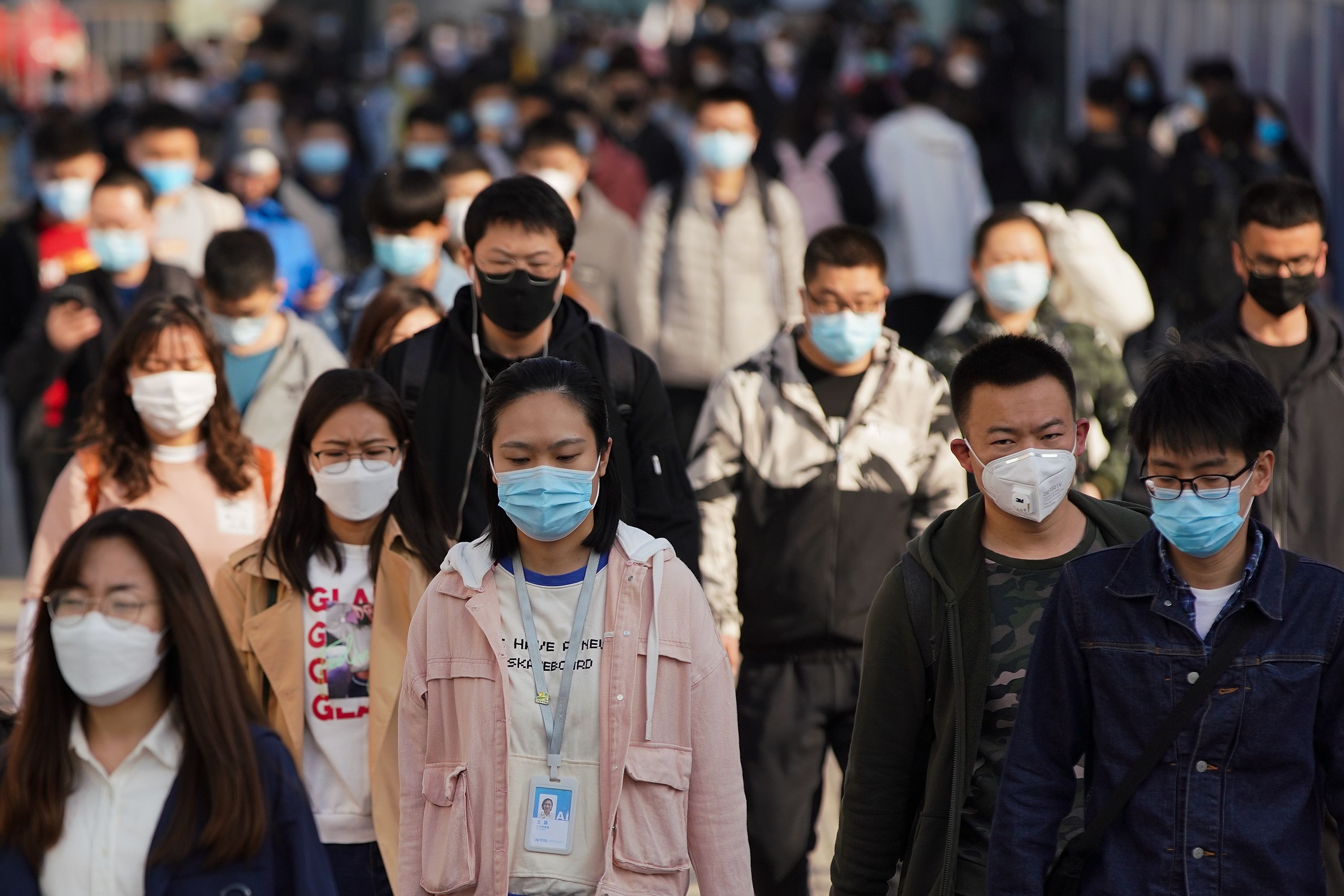 People in China wear masks to protect against COVID-19.