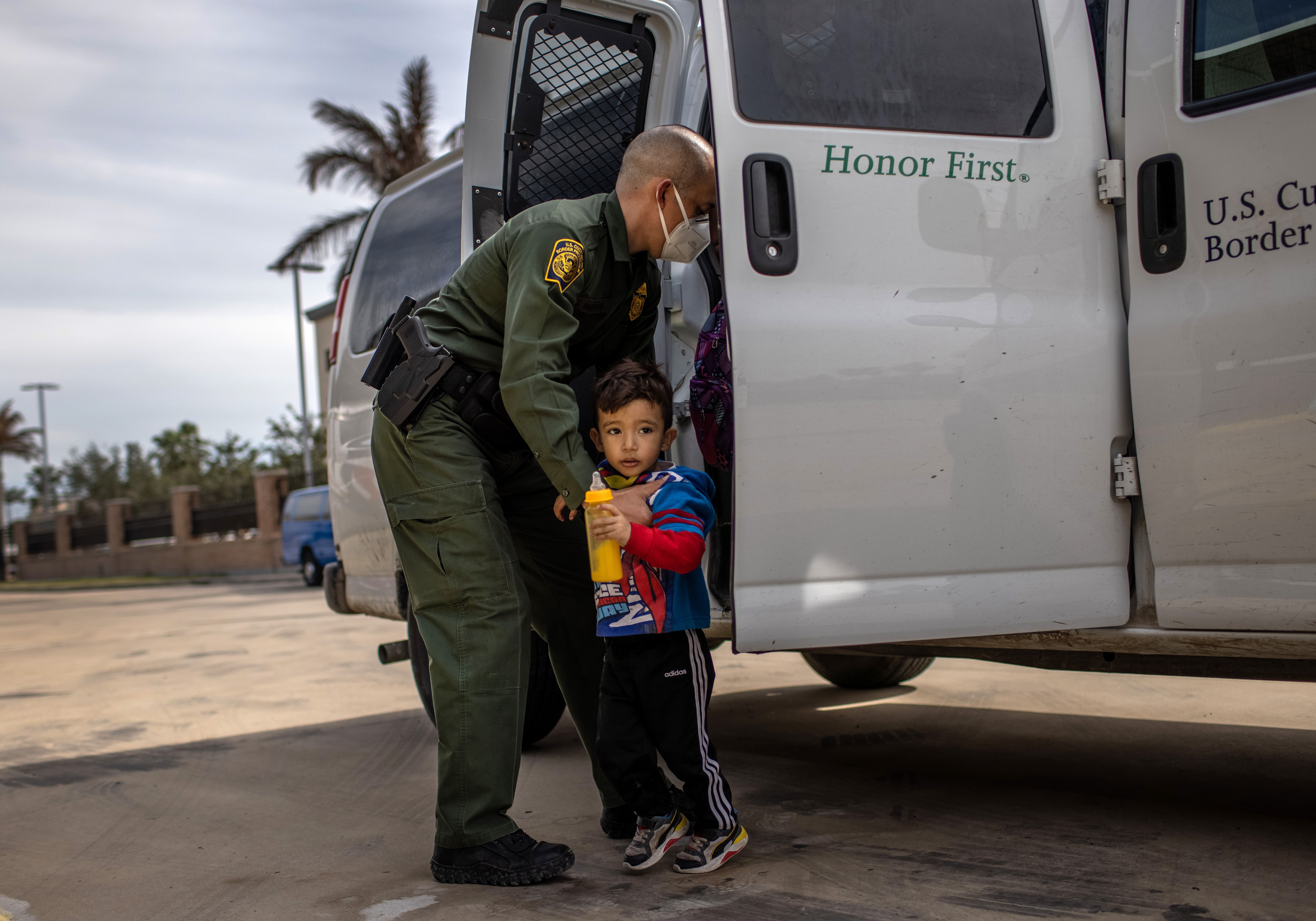 A Border Patrol officer with a child.