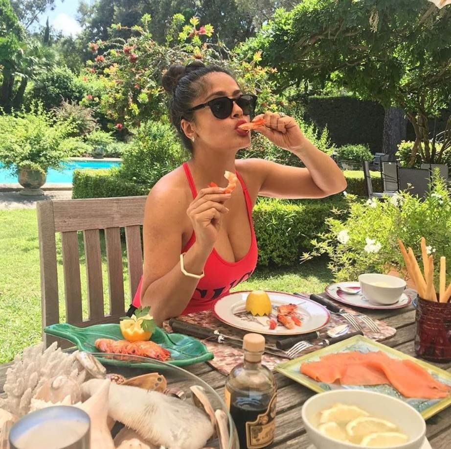SalmaHayek/Instagram snacking in swimsuit