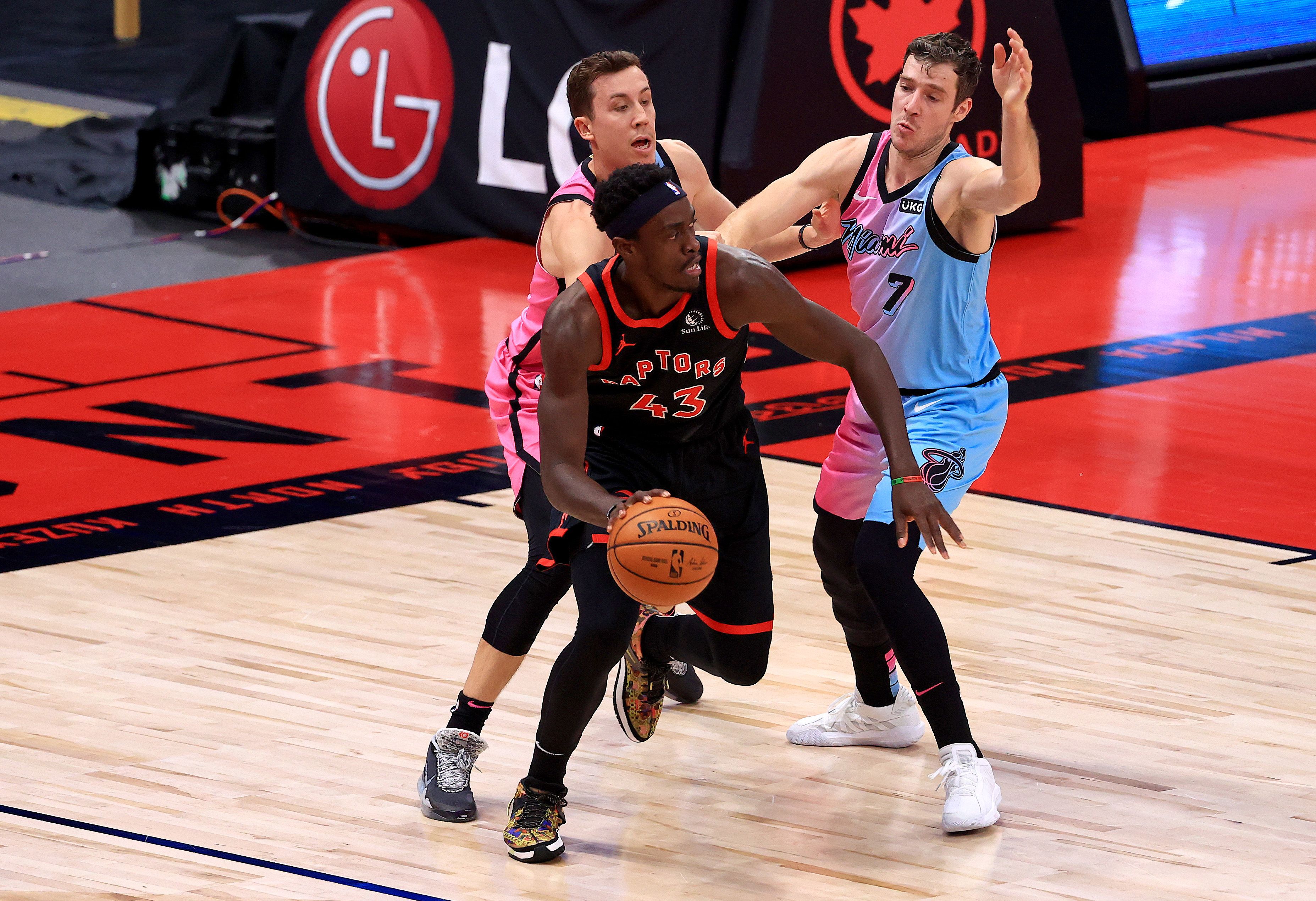 Pascal Siakam trying to protect the ball from Goran Dragic and Duncan Robinson