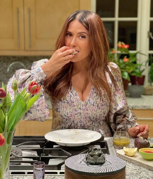 Salma Hayek snacking in a kitchen