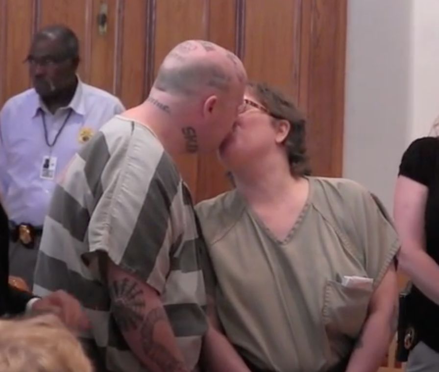 Jeremy Moody and Christine Moody kiss in court.