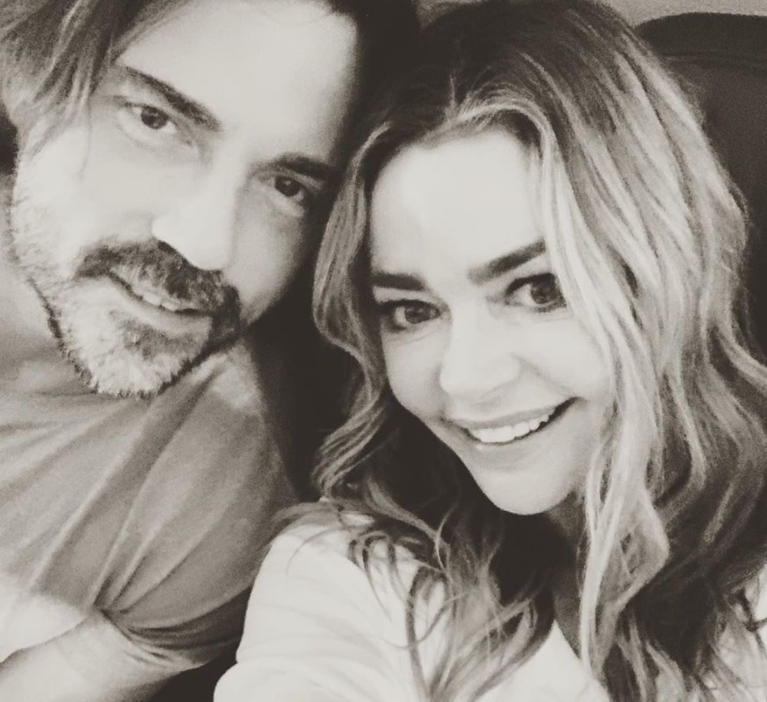 Aaron Phypers poses in a black and white image with wife Denise Richards.