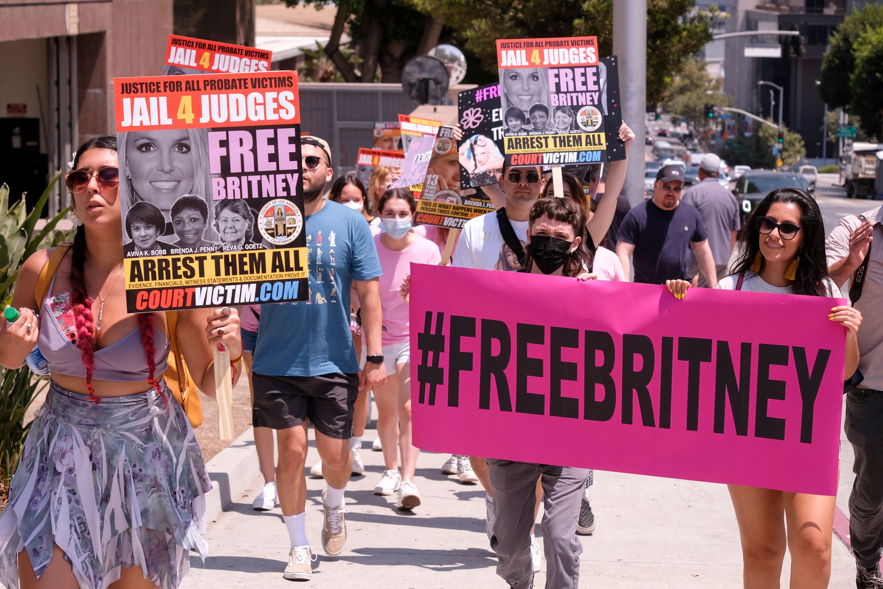 Protesters holding signs in support of ending the conservatorship of Britney Spears
