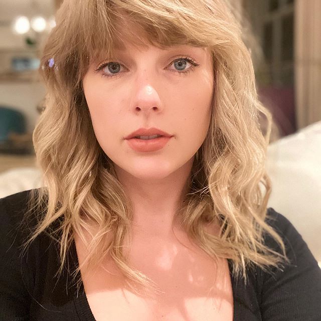 Taylor Swift looks into the camera while wearing minimal makeup.