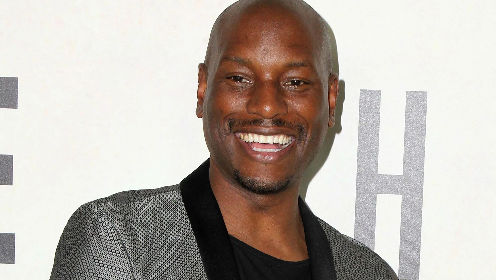 Tyrese Gibson smiles at an event.