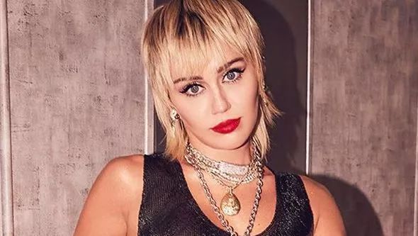 Miley Cyrus Lifts Shirt Without Bra To Deliver New Album